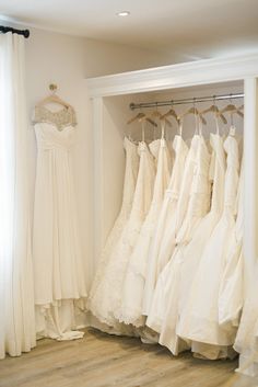 there are many dresses hanging in the closet