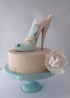 a cake with a flower and high heels on top