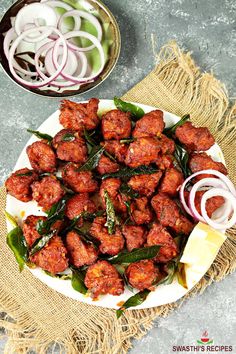 meatballs with onions and herbs on a plate