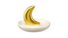 a golden banana sitting on top of a white bowl