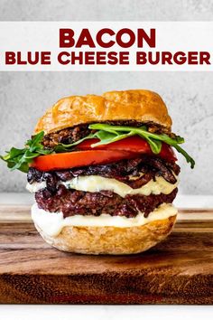 the bacon blue cheese burger is on a cutting board