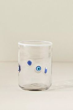 a clear glass with blue eyes on it