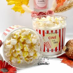 two cups filled with popcorn sitting next to each other on top of a white table