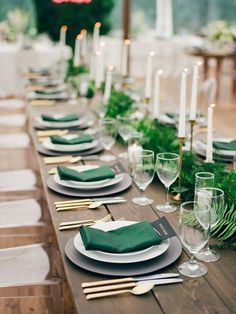 a long table with place settings and candles