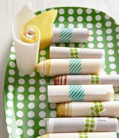 a green polka dot plate with napkins on it