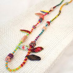 Add a pop of color and creativity to your outfit with this Unique Necklace for Woman. Handcrafted with fabric beads, this Boho Necklace is a standout piece of Textile Jewelry. Made with eco-friendly materials, this OOAK necklace is a perfect choice for the environmentally conscious fashionista. A statement accessory for any outfit , can be worn on both sides . Easy to wear and uniquely designed, this one of a kind necklace is ready to be shipped and is ideal for the creative lady looking to make Multicolor Wooden Beads For Festival, Eclectic Multicolor Beaded Necklace For Festivals, Playful Multicolor Beaded Necklaces For The Beach, Eclectic Multicolor Beads For Festival, Eclectic Multicolor Festival Beads, Fun Multicolor Beaded Necklaces For Beach, Fun Multicolor Beaded Necklace With Large Beads, Creative Woman, Sides Easy