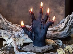 there is a fake hand with candles in it