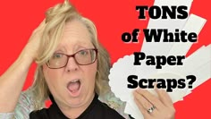 a woman holding up some paper with the text tons of white paper scraps?