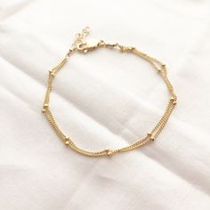 A perfect everyday dainty satellite bracelet.You can choose from 2-3 strands on a single bracelet. wear it by itself, or stack it with others. It makes the PERFECT gift for yourself or someone awesome! Wear your jewelry all day and night, even when washing your hands! We recommend cleaning your pieces once a week to keep them in great condition. Item Details:• This listing is for ONE(1) Layered satellite bracelet.• This bracelet comes with an adjustable extender for that perfect fit.• Length is Minimalist Multi-strand Everyday Jewelry, Minimalist Multi-strand Jewelry For Everyday, Minimalist Multi-strand Satellite Chain Jewelry, Delicate Multi-strand Jewelry For Everyday, Dainty Jubilee Chain Bracelet For Layering, Dainty Double Chain Everyday Jewelry, Delicate Chain Bracelet With Extender, Delicate Gold Bracelet With Satellite Chain, Dainty Sterling Silver Adjustable Bracelet For Everyday