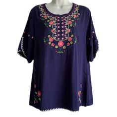 Nwt Tunic Top - Blue (Purple Blue In Direct Sun Light) - Embroidery Of Flowers On The Front, Sleeves, And Front Bottom - White Trimming Around Sleeves And The Hem Of The Top - Round Neckline - Pull Over Head Top - Short Sleeves (Sit Above Elbows) W/ A Split Opening 2” Detail - Top Hits Around Hip Level (Depending On Height) - Ethnic Appeal To The Top - Light Weight Material - Sz Medium (Shoulder To Shoulder 15.5”) Purple Casual Embroidered Top For Spring, Casual Purple Embroidered Top For Spring, Purple Embroidered Top With Floral Embroidery For Summer, Spring Purple Embroidered Cotton Top, Casual Purple Blouse With Floral Embroidery, Purple Floral Embroidered Top For Summer, Purple Embroidered Short Sleeve Top, Summer Purple Tops With Floral Embroidery, Embroidered Bohemian Purple Blouse