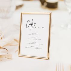 a close up of a menu on a table with gold and white decorations in the background