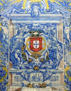 an ornate blue and yellow wall with a coat of arms on it