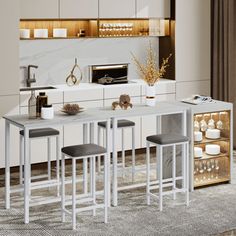 a kitchen table with stools in front of it and an oven on the other side