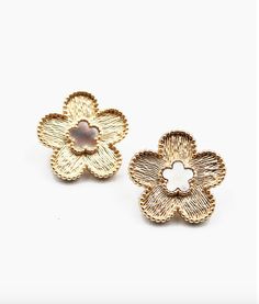 Post Back Closure Textured Gold Metal Flower with Mother of Pearl Center Light up your look with these stunning studs! These earrings feature a textured gold metal flower with a mother of pearl center, giving you a fun and unique way to add some sparkle to any outfit. Whether you're dressing up for a night out or just looking to make a statement, these clover stud earrings are sure to give you the perfect touch of whimsy and fun! 0.75W" x 0.75H" Gold Earrings With 3d Flowers For Spring, Gold Flower Earrings For Spring, Chic Metal Flower Earrings For Spring, Trendy Gold Flower Charm Earrings, Trendy Gold Flower Earrings, Spring Gold Metal Flower Earrings, Spring Gold Flower Earrings, Scarf Coverup, Rebecca Black