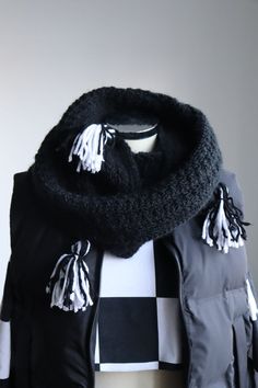 a black and white scarf with tassels on it