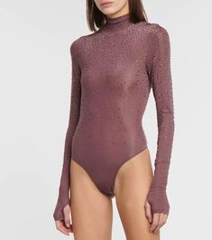 a woman is wearing a bodysuit with long sleeves