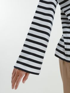 If you’re looking for the perfect French girl striped shirt with a twist, this is it. What sets it apart is the drop shoulder, slight bell sleeve, and sleek, flattering neckline. It’s a classic you’ll reach for in your closet, a reminder that you are a steady presence in this world. White Elegant Top With Contrast Stripes, Elegant White Top With Contrast Stripes, Chic Striped Hem Top For Fall, Elegant White Tops With Vertical Stripes, Elegant Long Sleeve Tops With Striped Cuffs, Classic Horizontal Stripe Tops For Fall, Classic Fall Tops With Horizontal Stripe Pattern, Classic Fall Tops With Horizontal Stripes, Classic Fall Tops With Contrast Stripes