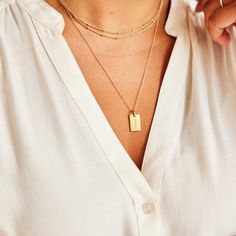 Our best selling tag now holds the name that matters most! This classic piece is beautiful on its own, but also pairs perfectly with our birthstone charms, and circle and heart tags. vermeil is a sterling silver base with 100+ mls of 24k gold mini dog tag is 5/8″ L x 1/3″ W "mama" engraved on front, no back engraving, ready to ship within 24 hours hangs on 18"chain *model is wearing the mama dog tag on a 24" chain layered with our 30" satellite chain Gold Hypoallergenic Charm Necklaces For Everyday, Everyday Gold Hypoallergenic Charm Necklaces, Everyday Minimalist Tarnish Resistant Charms, Everyday Minimalist Tarnish-resistant Charms, Everyday Engraved Gold Plated Charm Necklaces, Everyday Gold Nameplate Charm Necklaces, Everyday Gold Nameplate Charm Necklace, Everyday Engraved Gold Plated Charm Necklace, Everyday Gold Plated Engraved Charm Necklaces