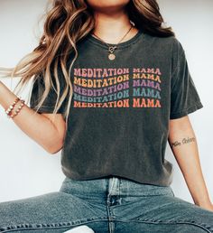 "Comfort Colors Meditation Mama T-shirt, Personalized Meditation Shirt, Retro Meditation, Retro Mama Tee Shirt, Groovy Mama Shirt https://toptrendtshirtsus.etsy.com NOTE: Please contact me for more size,color, product (sweatshirt, hoodies,kids etc) options. I'm always here to help. Unisex Garment-Dyed T-shirt Comfort Colors® 1717 *Medium fabric (6.1 oz/yd² (206.8 g/m *Relaxed fit *Sewn-in twill label *100% ring-spun cotton About Comfort Colors introduces its garment-dyed t-shirt; a fully customizable tee made 100% with ring-spun cotton. The soft-washed, garment-dyed fabric brings extra coziness to your wardrobe while the relaxed fit makes it an excellent daily choice. The double-needle stitching throughout the tee makes it highly durable while the lack of side-seams helps the shirt retain Comfortable Fit Graphic Tee With Short Sleeves, Relaxed Fit Multicolor Pre-shrunk Shirt, Trendy Tri-blend Soft-washed Tops, Funny Print Crew Neck Top With Comfortable Fit, Graphic Tee With Text Print And Crew Neck, Comfortable Fit Crew Neck Top With Funny Print, Casual Slogan Top With Comfortable Fit, Comfortable Fit Crew Neck Shirt With Graphic Print, Comfortable Crew Neck Shirt With Graphic Print