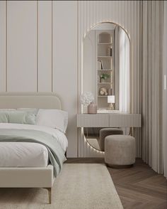 a white bed sitting next to a mirror on top of a wall