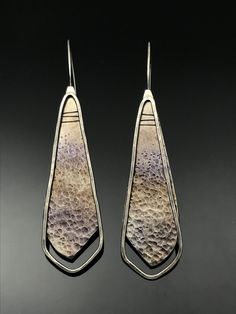 Silhouettes VI by Tavia Brown. Exploring juxtaposition with texture, materials, and movement, these earrings are created in titanium and sterling silver in a conversation of opposites. The titanium is adorned with a hammered texture and a slight patina. The sterling silver has a hammered texture. Silver Patina Drop Earrings, Silver Drop Earrings With Patina, Sterling Silver Patina Earrings, Textured Jewellery, Jewellery Project, Silhouette Earring, Hammered Silver Jewelry, Plain Silver Rings, Earring Inspiration