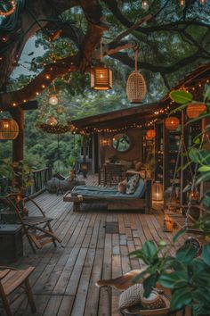 an outdoor deck is lit up with string lights and hanging lanterns above the seating area