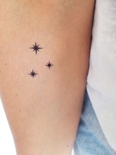 a woman's arm with three stars on it