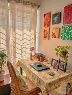 a dining room table and chairs in front of a window