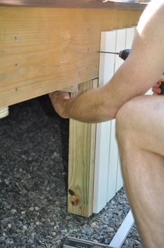 a man is working on a piece of wood