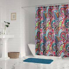 a colorful shower curtain in a white bathroom