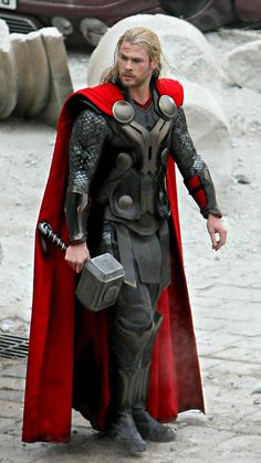 a man dressed as thor is walking down the street