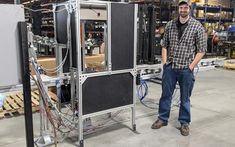 a man is standing in front of some equipment that are connected to wires and cables