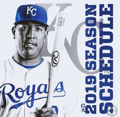 a man holding a baseball bat in front of a white and blue poster with the words royals on it