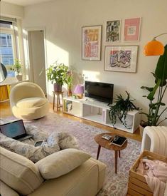 a living room filled with furniture and a flat screen tv