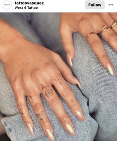 a woman's hand with tattoos on it