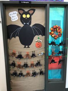 a door decorated with halloween decorations and bats