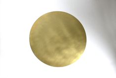 a gold disk is shown against a white background in this image, it appears to be half - circle