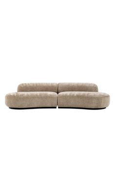 a large beige couch sitting on top of a white floor