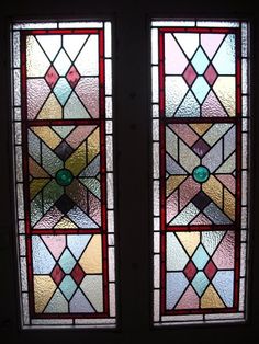 two stained glass windows with different colors and shapes on them, one is open to the other