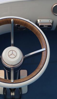 the steering wheel and center console of a modern car with wood trimming on it