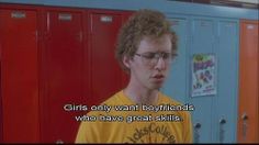 a young man with glasses standing in front of lockers