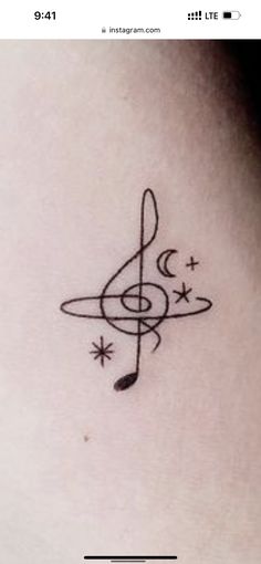 a music note tattoo on the back of a woman's neck