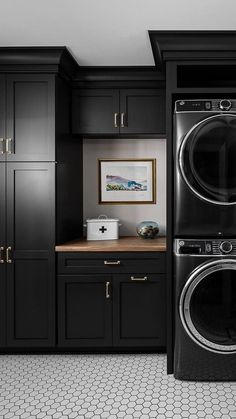 a black and white photo of a washer and dryer in a laundry room