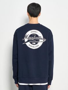 This is a comfortable and casual crewneck sweatshirt that is made out of sturdy cotton and polyester blend fabric. With a minimal yet unique design of graphic print on the back, logo embroidery on the front, and logo emblem embroidered on the left cuff, it gives a casual and trendy look. - Ribbed neckline, cuff, and hem- Graphic print on the back- Graphic logo embroidery on the front- Logo emblem embroidery on the sleeve- Relaxed silhouette Navy Long Sleeve Sweatshirt With Embroidered Logo, Navy Crew Neck Sweater With Embroidered Logo, Sporty Navy Sweatshirt With Graphic Print, Navy Cotton Sweatshirt With Logo Print, Navy Cotton Sweatshirt With Embroidered Logo, Navy Sporty Sweatshirt With Graphic Print, Navy Crew Neck Sweatshirt With Logo, Navy Crew Neck Sweatshirt With Logo Print, Navy Graphic Print Sweatshirt For Fall