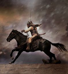 a man riding on the back of a black horse in front of a cloudy sky