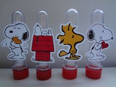 three plastic cups with stickers depicting snoopy and charlie the pooh on them