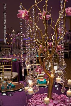 the centerpieces are adorned with pink flowers and crystal beads, along with candles