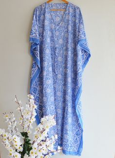 This Beautiful Hand Block Print Caftan or can be called as Tunic is made with super fine quality cotton and designs have been crafted by Hand Prints. Usage - Tunic, Gown, Maxi, Bikini Cover up, Beach Wear, Caftan etc. Fabric - 100% Cotton Color - Blue Pattern - Floral Size - Plus Size, can fit Upto 4XL Bust/chest size - Free Size ( Drawstring ) Length - Long Caftan- 50 Inches Approx Length - Short Caftan - 29 Inches Approx * It has Adjustable Drawstring Waist. * V Shape Neck Which is 8" Inches D Blue Bohemian Tunic For Daywear, Traditional Summer Kaftan For Daywear, Long Bohemian Kaftan For Daywear, Bohemian Tunic Kaftan For Daywear, Bohemian Blue Kimono For Daywear, Bohemian Tunic Kaftan, Blue Bohemian Kimono For Daywear, Long Kaftan For Beach Daywear, Bohemian Flowy Kaftan For Daywear