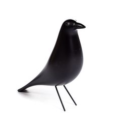 a black bird sitting on top of a metal stand