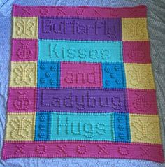 a crocheted blanket with words written in different colors and sizes on the bottom